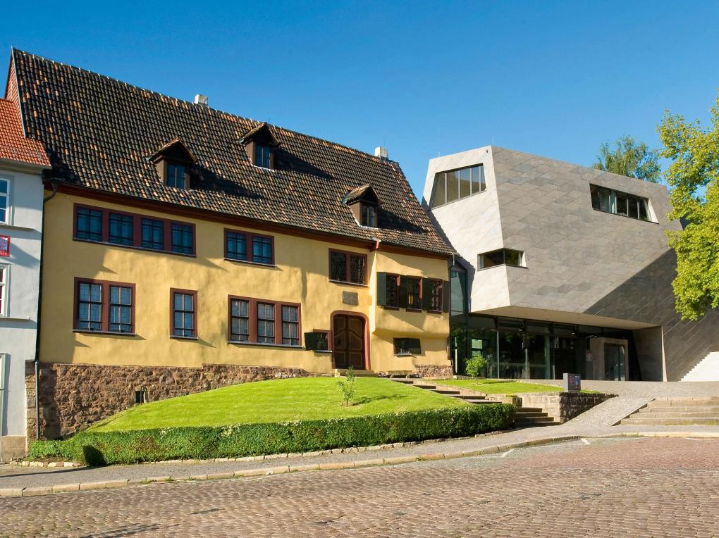 Außenansicht eines älteren Gebäudes neben einem modernen Gebäudeteil